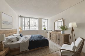 Baltimore apartment for rent - a bedroom with a bed and a dresser and a window