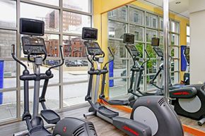 Baltimore apartment for rent - a gym with cardio machines and a view of a city street