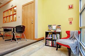Baltimore apartment for rent - a dining room with a table and chairs and a book shelf with books