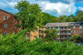 Bladensburg apartment for rent - a view of an apartment building with trees and bushes