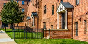 Hyattsville apartment for rent - a brick building with a wrought iron fence