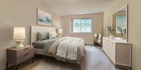 Hyattsville apartment for rent - a bedroom with a bed and a dresser and a window