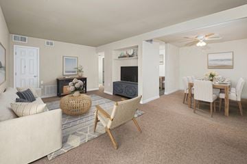 Greenbelt apartment for rent - a living room and dining room with a couch and a table