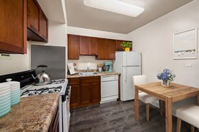 Greenbelt apartment for rent - a kitchen with white appliances and a wooden table