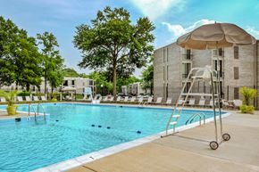 Greenbelt apartment for rent - a swimming pool with an umbrella next to a building
