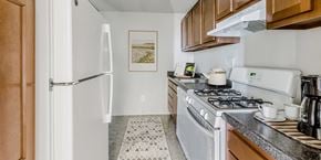 Alexandria apartment for rent - full kitchen with white appliances and wood cabinets at the preserve at polk apartments