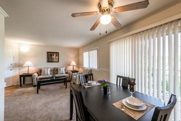 Laurel apartment for rent - a living room with a dining room table and a ceiling fan