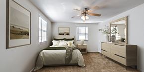 Woodbridge apartment for rent - a bedroom with a ceiling fan and a bed