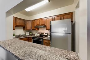 Columbia apartment for rent - a kitchen with a granite counter top and a stainless steel refrigerator