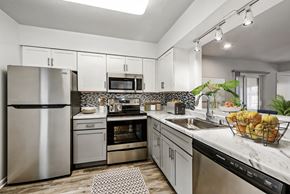 Rockville apartment for rent - a kitchen with stainless steel appliances and marble counter tops