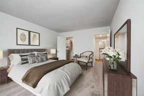 Rockville apartment for rent - a bedroom with a large bed and a vase of flowers