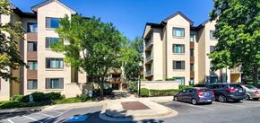 Rockville apartment for rent - a parking lot with cars in front of an apartment building