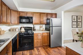 Crofton apartment for rent - a kitchen with black appliances and wooden cabinets