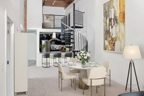 Ellicott City apartment for rent - a dining room with a table and chairs and a spiral staircase
