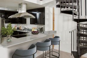 Ellicott City apartment for rent - a kitchen with a counter and chairs and a spiral staircase