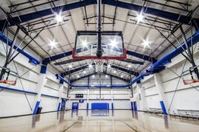Oxon Hill apartment for rent - a basketball hoop hangs from the ceiling of a large gymnasium