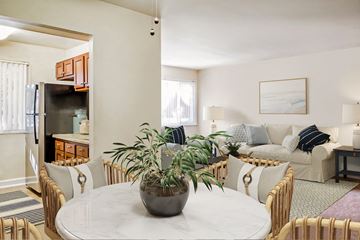 Oxon Hill apartment for rent - a living room and dining room with a white marble table and a plant