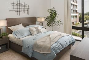 Towson apartment for rent - a bedroom with a bed and a large window