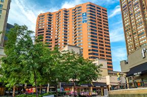 Baltimore apartment for rent - A tall orange building with a blue sign on it.
