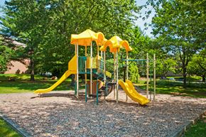 Baltimore apartment for rent - a playground with a yellow playset in a park