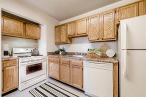 Annandale apartment for rent - a kitchen with white appliances and wooden cabinets