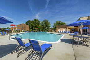 Annandale apartment for rent - our apartments have a resort style pool with blue chairs and umbrellas