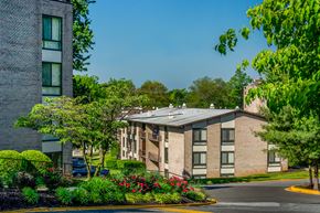 Capitol Heights apartment for rent - a brick building with a solar roof on the corner of a street
