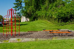 Capitol Heights apartment for rent - a playground with a red tower and a bench