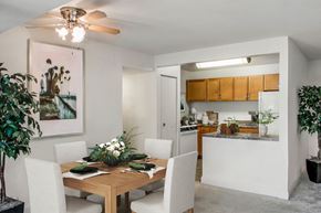 Beltsville apartment for rent - a dining room and kitchen with a table and chairs