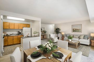 Beltsville apartment for rent - a living room and kitchen with a table and chairs