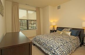 Hanover apartment for rent - A bedroom with a large bed and a wooden desk.