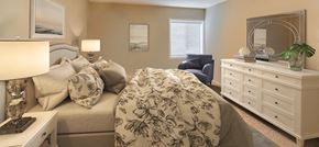 Pikesville apartment for rent - a bedroom with a bed and a dresser with a mirror