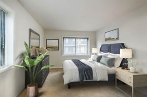 Hyattsville apartment for rent - a bedroom with a bed and a dresser and a window