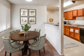 Vienna apartment for rent - a dining room with a wooden table and chairs next to a kitchen