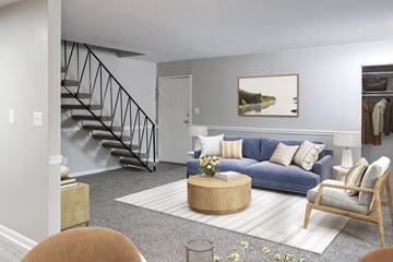 Riverdale apartment for rent - A living room with a blue couch, a coffee table, and a painting on the wall.
