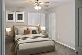 Riverdale apartment for rent - A bedroom with a large bed and two lamps.
