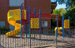 Riverdale apartment for rent - a childrens playground with a yellow slide