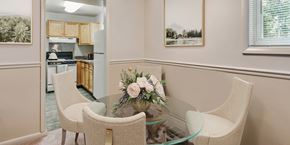 Woodbridge apartment for rent - a dining room table with chairs and a vase of flowers