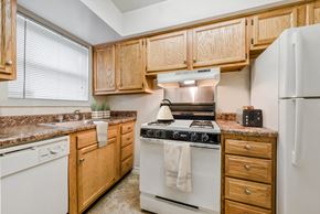 Woodbridge apartment for rent - an updated kitchen with white appliances and wooden cabinets