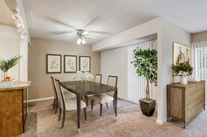 Lanham apartment for rent - a dining room with a table and chairs and a ceiling fan