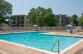Lanham apartment for rent - a swimming pool with an apartment building in the background