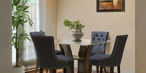 Landover apartment for rent - a dining room table with blue chairs and a potted plant