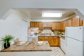 Alexandria apartment for rent - a kitchen with white appliances and wooden cabinets