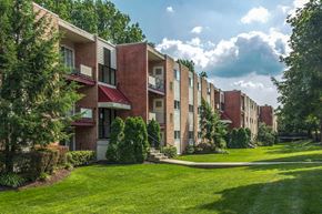 Windsor Mill apartment for rent - a row of brick apartment buildings with green grass and trees