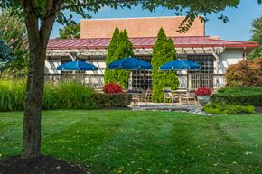 Windsor Mill apartment for rent - a patio with umbrellas in front of a building