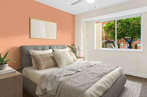 Silver Spring apartment for rent - a bedroom with an orange wall and a bed with pillows