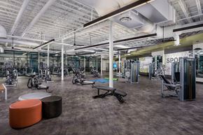 Silver Spring apartment for rent - a gym with exercise machines and other equipment in a building with cement floors