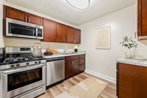 Silver Spring apartment for rent - a kitchen with stainless steel appliances and wooden cabinets
