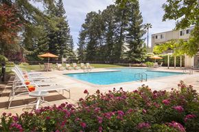 San Jose apartment for rent - a swimming pool with lounge chairs next to a hotel pool