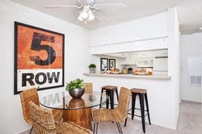 Gilroy apartment for rent - a dining room with a table and chairs and a kitchen in the background